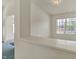 Upstairs loft area with window and neutral paint, and blue carpeting in the hall at 2755 Rylee Ct, Greenwood, IN 46143