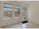 A bright sunroom with neutral tile flooring, three windows, and a glass door to the outside deck at 2755 Rylee Ct, Greenwood, IN 46143