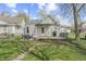 Backyard features a deck, grill, outdoor seating, green grass, and provides ample space for activities at 282 N Vine St, Plainfield, IN 46168