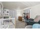 Bedroom with a crib, neutral decor, and cozy seating at 282 N Vine St, Plainfield, IN 46168
