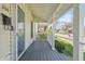 View of the home's charming covered front porch with painted wood floors and white columns at 282 N Vine St, Plainfield, IN 46168