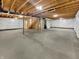 Unfinished basement with exposed wood beams, concrete floor, and white plastic-lined walls at 2859 Dursillas Dr, Plainfield, IN 46168