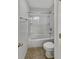 Full bath with white tub and shower combination, white toilet, and tiled floor at 2859 Dursillas Dr, Plainfield, IN 46168