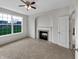 Bedroom featuring a cozy fireplace, window, and neutral carpet at 2859 Dursillas Dr, Plainfield, IN 46168