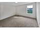 Carpeted bedroom featuring a large window with backyard view and neutral walls at 2859 Dursillas Dr, Plainfield, IN 46168