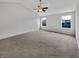 Spacious carpeted bedroom with a vaulted ceiling, ceiling fan and two windows at 2859 Dursillas Dr, Plainfield, IN 46168