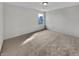 Empty carpeted bedroom with neutral color scheme and a large window to let in natural light at 2859 Dursillas Dr, Plainfield, IN 46168