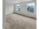 A bright bedroom with neutral carpet and two windows offering views of the exterior at 2859 Dursillas Dr, Plainfield, IN 46168