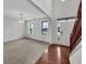 Bright and airy living room with large windows and modern chandelier, with hardwood stairs at 2859 Dursillas Dr, Plainfield, IN 46168