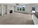 Spacious living room featuring a fireplace, large windows, and neutral carpet at 2859 Dursillas Dr, Plainfield, IN 46168