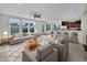Open-concept living room featuring a plush rug, gray sofa, and seamless flow into the kitchen and a breakfast bar at 2859 Dursillas Dr, Plainfield, IN 46168
