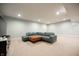 Finished basement featuring plush carpeting, recessed lighting, and a comfortable blue leather sectional with an ottoman at 2932 Camden Ct, Greenwood, IN 46143