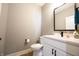Bathroom with a white vanity, black framed mirror and faucet, with a white toilet at 2932 Camden Ct, Greenwood, IN 46143