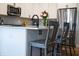 Modern kitchen island with white cabinetry, quartz countertop, seating, and stainless steel appliances at 2932 Camden Ct, Greenwood, IN 46143