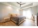 Light-filled main bedroom with tray ceiling, hardwood floors, and a comfortable queen-sized bed at 2932 Camden Ct, Greenwood, IN 46143
