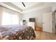 Spacious main bedroom featuring a desk, TV, and a cozy floral comforter at 2932 Camden Ct, Greenwood, IN 46143