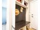 Mudroom featuring a built-in bench, coat hooks, and storage shelves, offering a practical entryway solution at 2932 Camden Ct, Greenwood, IN 46143