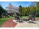 Landscaped backyard with patio featuring a fire pit, seating, and a playground, perfect for outdoor relaxation and entertainment at 3165 Hazel Foster W Ct, Carmel, IN 46033