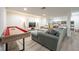 Finished basement with a play area, shuffleboard table, and comfortable gray sectional at 3165 Hazel Foster W Ct, Carmel, IN 46033