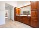 Spacious bathroom boasts a double vanity with ample storage, updated lighting, and neutral-toned tile floors at 3165 Hazel Foster W Ct, Carmel, IN 46033