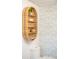 Stylish bathroom wall decor with decorative wallpaper and bamboo shelving, adding charm to the space at 3165 Hazel Foster W Ct, Carmel, IN 46033