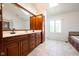 Spacious bathroom with double vanity, dark wood cabinetry and granite counters at 3165 Hazel Foster W Ct, Carmel, IN 46033