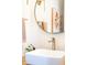 Modern bathroom sink featuring a square white basin, brushed gold faucet and fixtures, plus tasteful décor at 3165 Hazel Foster W Ct, Carmel, IN 46033