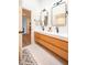 Well-lit bathroom featuring a double sink vanity with wood cabinets and modern fixtures at 3165 Hazel Foster W Ct, Carmel, IN 46033