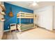 Vibrant bedroom with bunk beds, blue accent wall, and stylish decor at 3165 Hazel Foster W Ct, Carmel, IN 46033