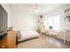 Sunlit bedroom with a functional workspace, modern decor, and a comfortable bed at 3165 Hazel Foster W Ct, Carmel, IN 46033