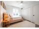 Bright bedroom features a bed, ceiling fan, closet, and hardwood floors, creating a comfortable retreat at 3165 Hazel Foster W Ct, Carmel, IN 46033