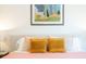 Close up of a bed with plush pillows and bright bedding in a naturally lit bedroom at 3165 Hazel Foster W Ct, Carmel, IN 46033