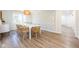 Dining room features hardwood floors, a large picture window, modern light fixture, and designer wallpaper at 3165 Hazel Foster W Ct, Carmel, IN 46033