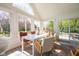 Sunlit dining room with a white table, stylish chairs, and a sliding glass door to patio at 3165 Hazel Foster W Ct, Carmel, IN 46033