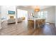Open-concept living and dining room with hardwood floors, white brick fireplace, and view to the living room at 3165 Hazel Foster W Ct, Carmel, IN 46033