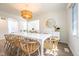 Bright dining room features hardwood floors, large windows, and modern light fixture with views to the living room at 3165 Hazel Foster W Ct, Carmel, IN 46033