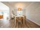 Dining room features hardwood floors, a large picture window, modern light fixture, and designer wallpaper at 3165 Hazel Foster W Ct, Carmel, IN 46033