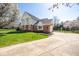 Wide driveway leading to a well-kept home, featuring a basketball hoop and lush green lawn at 3165 Hazel Foster W Ct, Carmel, IN 46033