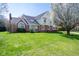 Attractive two-story home with brick accents, a manicured lawn, and mature trees enhancing its curb appeal at 3165 Hazel Foster W Ct, Carmel, IN 46033
