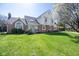 Charming brick and siding two-story home with manicured lawn and beautiful mature tree at 3165 Hazel Foster W Ct, Carmel, IN 46033