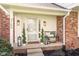 Inviting front porch with decorative plants, bench seating, and stylish lanterns at 3165 Hazel Foster W Ct, Carmel, IN 46033