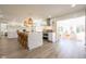 Open-concept kitchen with white cabinetry, stainless steel appliances, kitchen island with seating, and great natural light at 3165 Hazel Foster W Ct, Carmel, IN 46033