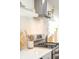 Modern kitchen with stainless steel appliances, a stylish range hood, and ample counter space for cooking at 3165 Hazel Foster W Ct, Carmel, IN 46033