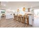 Bright kitchen with island seating, modern lighting, and ample counter space for culinary enthusiasts at 3165 Hazel Foster W Ct, Carmel, IN 46033