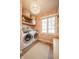 Charming laundry room with modern washer and dryer and decorative floral wallpaper at 3165 Hazel Foster W Ct, Carmel, IN 46033