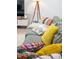 Close-up of a comfortable grey sofa with colorful decorative pillows in a well-lit living room at 3165 Hazel Foster W Ct, Carmel, IN 46033