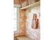 Stylish mudroom featuring floral wallpaper, wooden hooks, and a built-in bench seat at 3165 Hazel Foster W Ct, Carmel, IN 46033