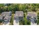 An aerial view shows a landscaped yard, three-car garage, and proximity to mature trees at 4285 Nottinghill Dr, Avon, IN 46123