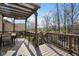 An elevated deck features a wooden pergola, play set and view of the back yard at 4285 Nottinghill Dr, Avon, IN 46123