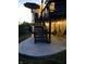 Back patio with stairs to multi-level deck and string lights, outdoor furniture, and potted flowers at 4285 Nottinghill Dr, Avon, IN 46123